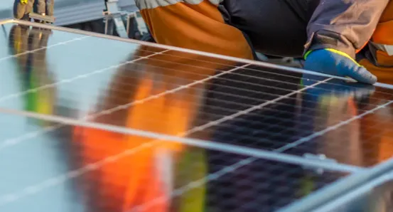 Worker installing solar panels
